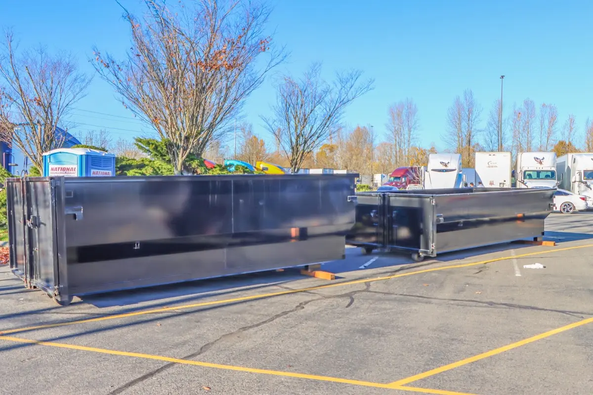 Professional dumpster rental service with roll-off container on residential driveway in Andover